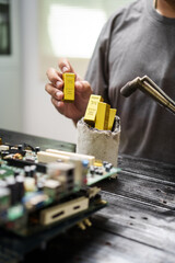 Factory worker overseas molten metal pouring into mold, surrounded by glowing heat in a steel foundry. Microchips and computer hardware components semiconductor and gold metal manufacturing.