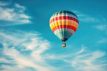 Naklejka premium photo of a hot air with colorful strip balloon in blue sky