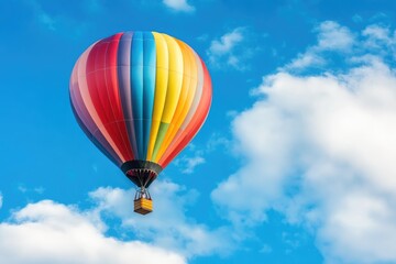Fototapeta premium photo of a hot air with colorful strip balloon in blue sky
