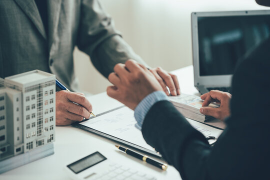 Real estate agent shows a sample home to a client after signing a contract with an approved loan application. Negotiating real estate details.