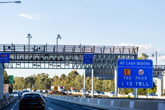 E-tag toll road start sign above highway with licence plate cameras