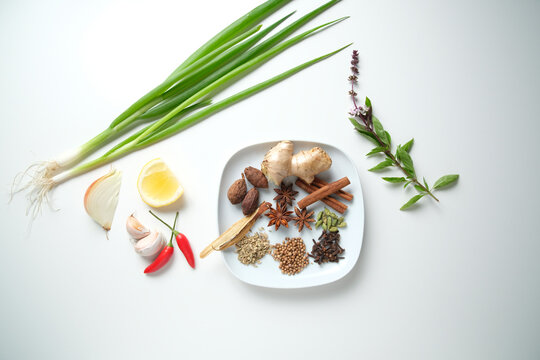 Spices and herbs on white table