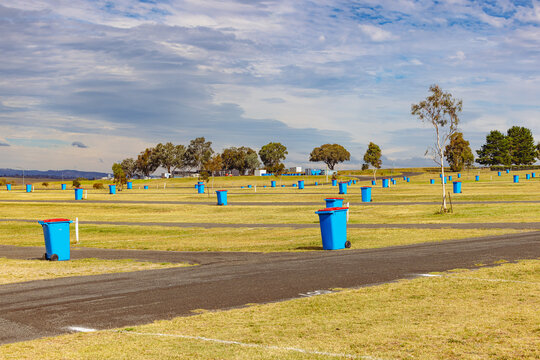 Blue wheelie rubbish bins dotted throughout grounds of Mount Panorama