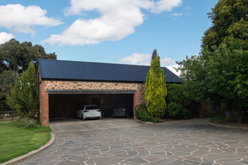 two cars parked in a stone garage