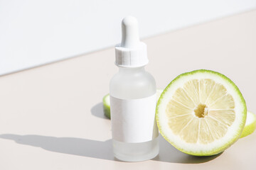 Front view of frosted serum bottle with lemon