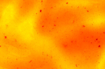 Texture of orange sea buckthorn jam, top view. Orange spot of sea buckthorn jam. Spilled spot of sea buckthorn jam, background, texture, top view. Orange background of fruit jam, top view.