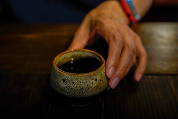 hands holding cup of tea