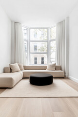 Stylish modern living room featuring a neutral color palette and large windows for bright, natural light in a contemporary apartment