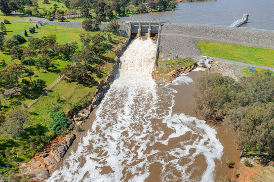 Aerial view of water gushing from dam gates of a reservoir