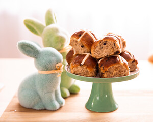 easter hot cross buns on a table with rabbit decor