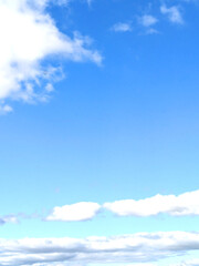 Fluffy White Clouds in a Blue Sky as A Skyscape Background