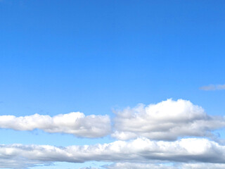 Fluffy White Clouds in a Blue Sky as A Skyscape Background