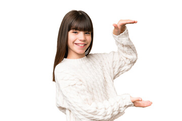 Little caucasian girl over isolated background holding copyspace to insert an ad