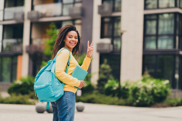 Photo of carefree cheerful cute girl wear yellow trendy clothes going lecture lesson fall season day outdoors