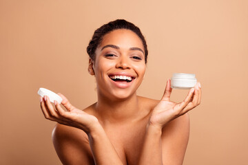 Photo of stunning dreamy lady hold cream jar bare shoulders isolated on beige pastel color...