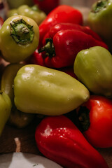 colorful assortment of fresh bell peppers in the kitchen, vibrant green and red peppers on the table, preparing for cooking