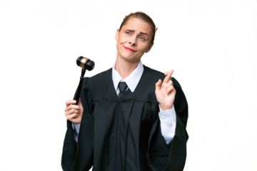 Judge caucasian woman over isolated background with fingers crossing and wishing the best