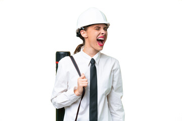 Young architect woman with helmet and holding blueprints over isolated background laughing in lateral position