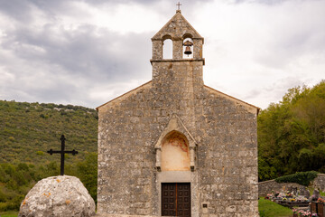 Naklejka premium The Church of St. Mary of Lakuć in Dvigrad, Croatia, in Gothic style with a spindle-shaped bell tower and semicircular decorated apse. It houses a collection of frescoes by a 15th-century artist.