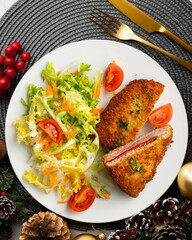 Asturian Cachopo. Breaded beef fillet stuffed with cheese and pepper. Top view table with Christmas decoration.