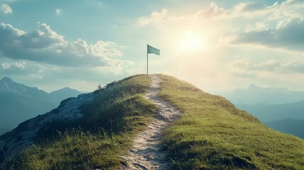 A winding path leads to a flag on a mountain peak, with a view of more mountains in the distance.