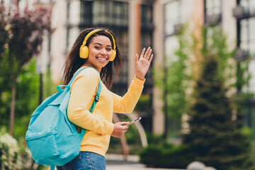 Naklejka premium Photo of cheerful positive cute girl wear yellow trendy clothes going lessons spring day outdoors