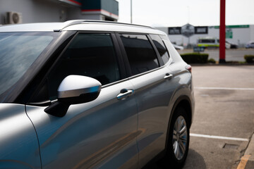 silver car wagon suv parked petrol station tinted windows