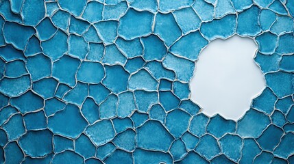 An abstract image showing an asymmetric arrangement of cracked blue tiles surrounding a central white space, representing the concept of imperfection and contrast.