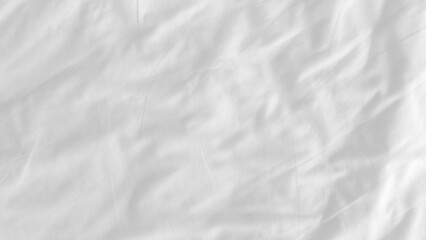 White wrinkled bed sheet. Soft fabric background. Cloth surface backdrop. Sleep and relaxation concept.