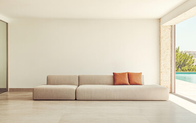Modern living room with a minimalist design featuring a cozy sofa and large windows overlooking a serene outdoor space