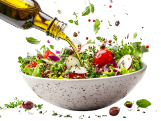 Fresh salad being drizzled with olive oil, showcasing vibrant colors and healthy ingredients.