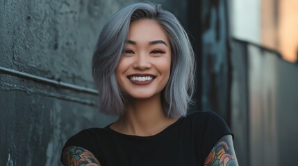 Fototapeta premium Stylish Asian Woman with Silver Shoulder Length Hair Smiling Against Urban Wall, Suitable for Lifestyle and Fashion Publications