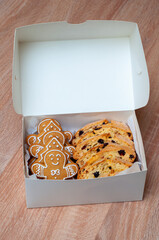 Gingerbread cookies and biscotti neatly packed in a white box, perfect for Christmas treats.