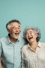 An old Asian couple dressed in casual everyday wear, caught in a moment of shared laughter happy lovebird on the solid background
