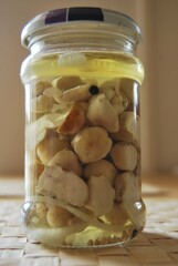 boletus mushrooms in a jar in vinegar marinade