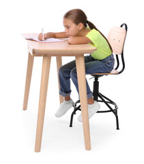 Girl with incorrect posture and notebook sitting at wooden desk on white background