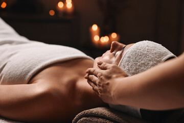Attractive woman enjoying face massage, closeup. Beauty procedure