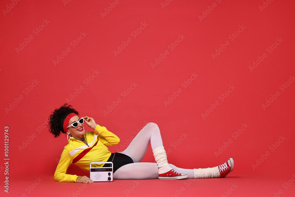 Sticker Aerobics. Woman in sportswear holding radio receiver on red background