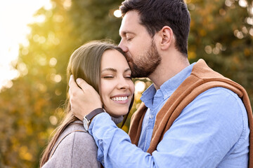 Fototapeta premium Beautiful couple spending time together outdoors on autumn day