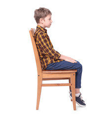 Boy with correct posture sitting on chair against white background
