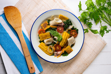 Mediterranean corn salad with squid. Top view table with  decorations.