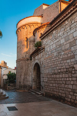 Krk Croatia 28.06.24A quiet street at dawn near an old church