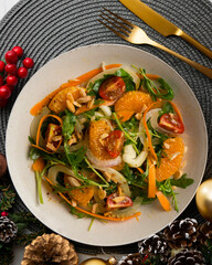 Healthy green fennel and mandarin salad. Top view table with Christmas decorations.