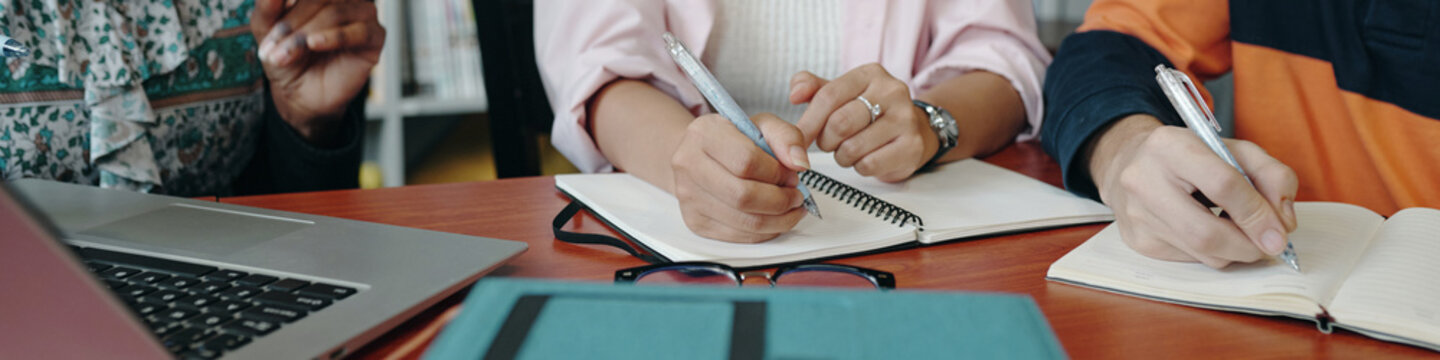 Header with students doing homework in team