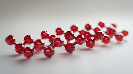 A close-up view of a complex molecular structure modeled with red geometric shapes on a smooth gradient background