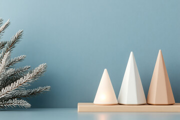 Minimalist Christmas scene with cone shaped decorations and a frosted pine branch