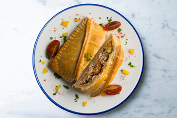 Galician empanada with vegetables and fish. Top view table with  decorations.