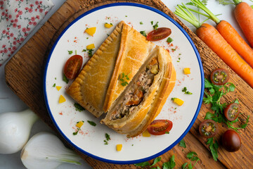 Galician empanada with vegetables and fish. Top view table with  decorations.