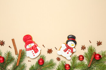 Flat lay composition with Christmas decor and delicious cookies in shape of snowmen on beige...