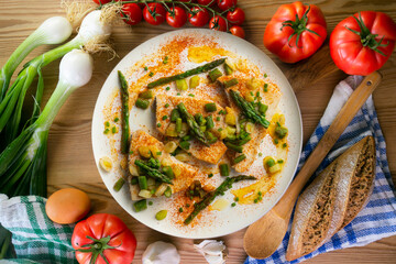 Grilled swordfish with green asparagus. Top view table with  decorations.